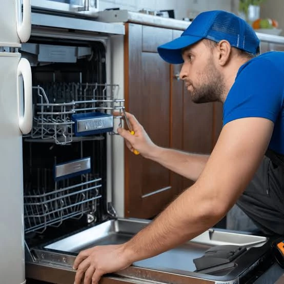 Technician inspecting an open double-drawer dishwasher